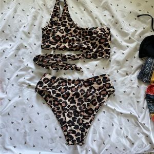 Size M leopard asymmetrical high rise bikini. Light pilling on bottoms.